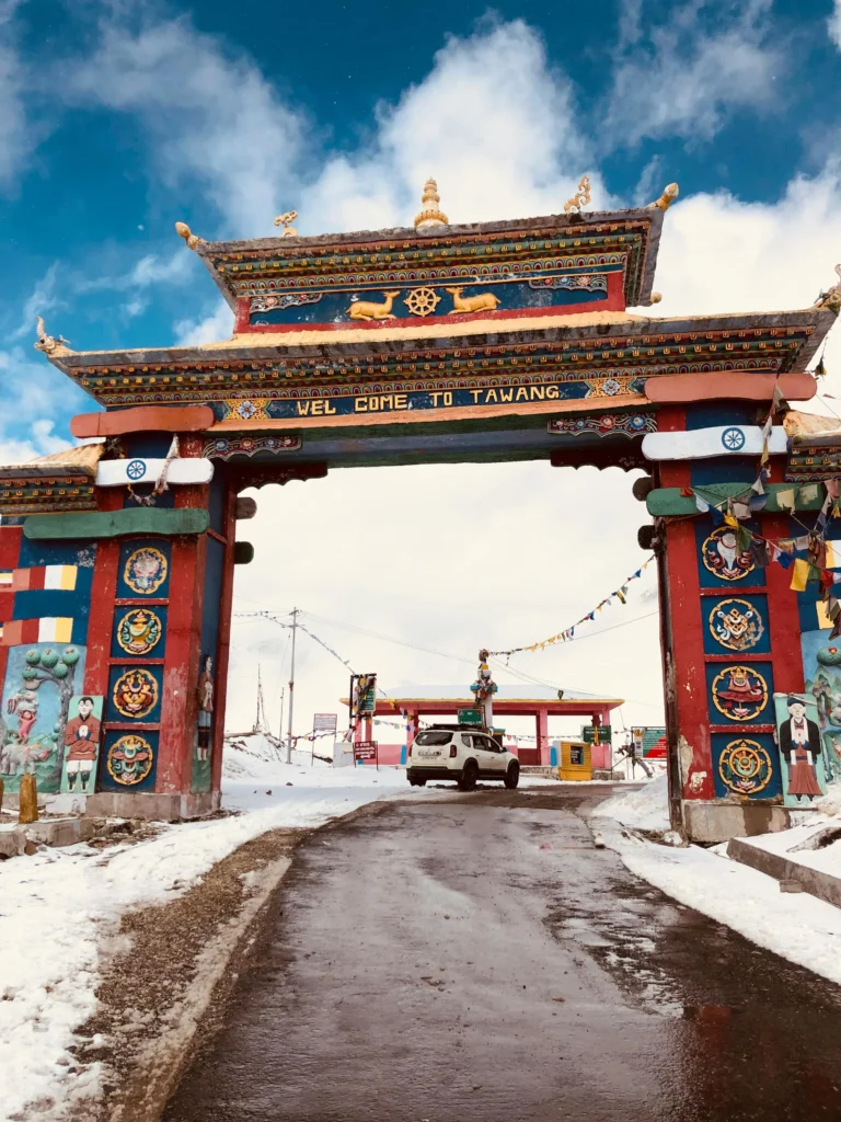 Scenic view of Tawang Monastery surrounded by snow-capped mountains in Arunachal Pradesh, a popular tourist spot in Northeast India known for its spiritual significance and breathtaking landscapes.