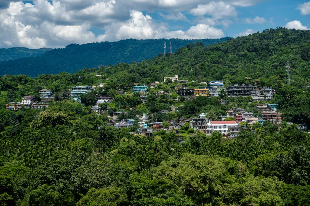 Panoramic view of  Shillong, Meghalaya, surrounded by lush green hills, showcasing one of the most serene tourist spots in Northeast India