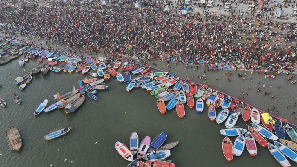 Boats filled with devotees traveling across the river during the Kumbh Mela, capturing the essence of spiritual journey and devotion."