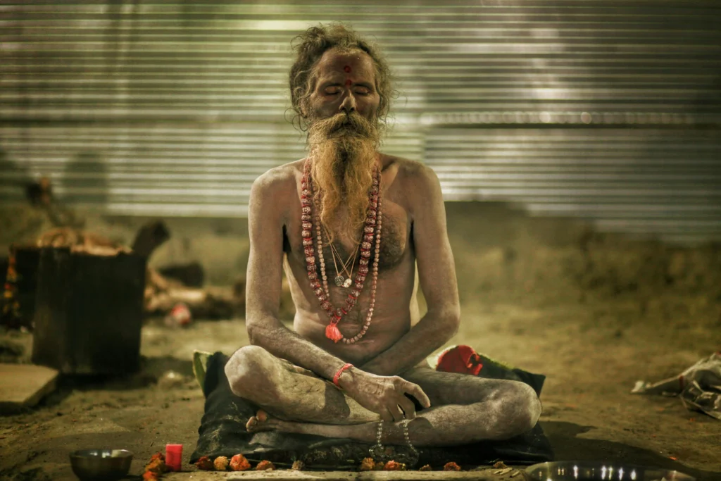 A Naga Sadhu meditating in deep dhyan posture during the Kumbh Mela.