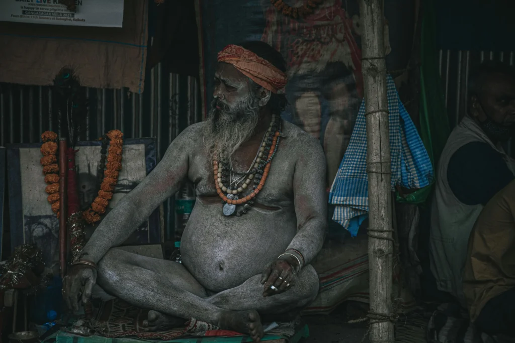 A Naga Sadhu seated in a meditative posture, exuding calm and spiritual focus during the Kumbh Mela.