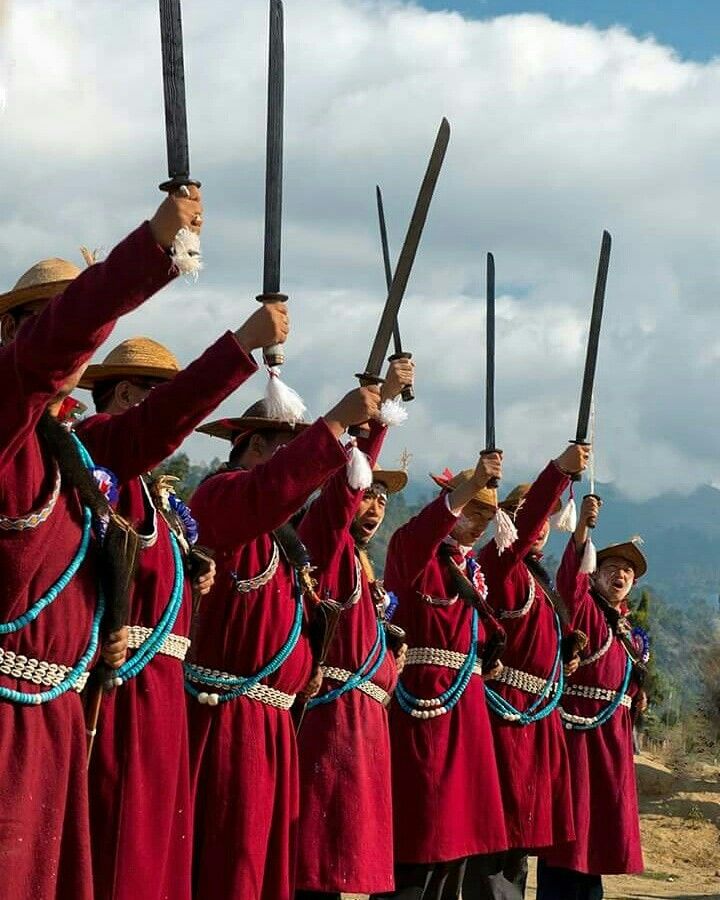 Tagin tribe wearing traditional handwoven shawls and decorations"